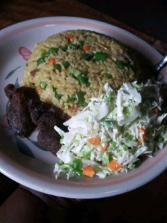 A picture of Coconut rice and fried meat and salad.