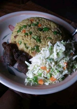 A picture of Coconut rice and fried meat and salad.