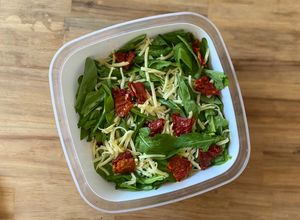 Una foto de Ensalada de arúgula, tomates secos y queso