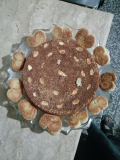 A picture of Eid special Almond cake and heart shape cookies.
