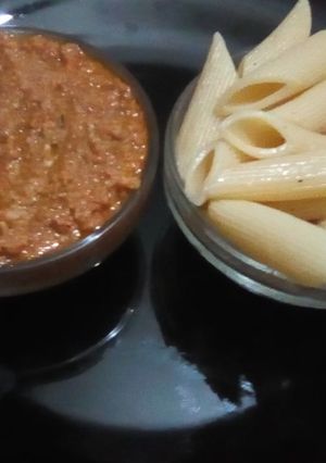 A picture of Pasta with red sauce meat.