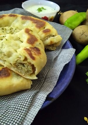 A picture of Aloo kabab naan without oven serve with raita.