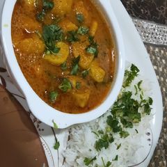 A picture of Moong Dal steam pakode with curry.