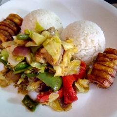 A picture of White Rice with vegetable chicken sauce.