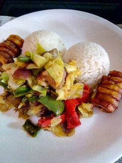 A picture of White Rice with vegetable chicken sauce.