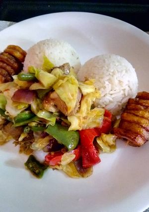 A picture of White Rice with vegetable chicken sauce.