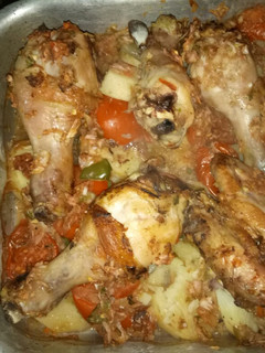 A picture of Baked Chicken and Potato Slices.