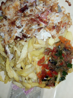 A picture of Chips & egg with sauce.