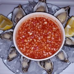 A picture of Oysters on the half shell with Mignonette.