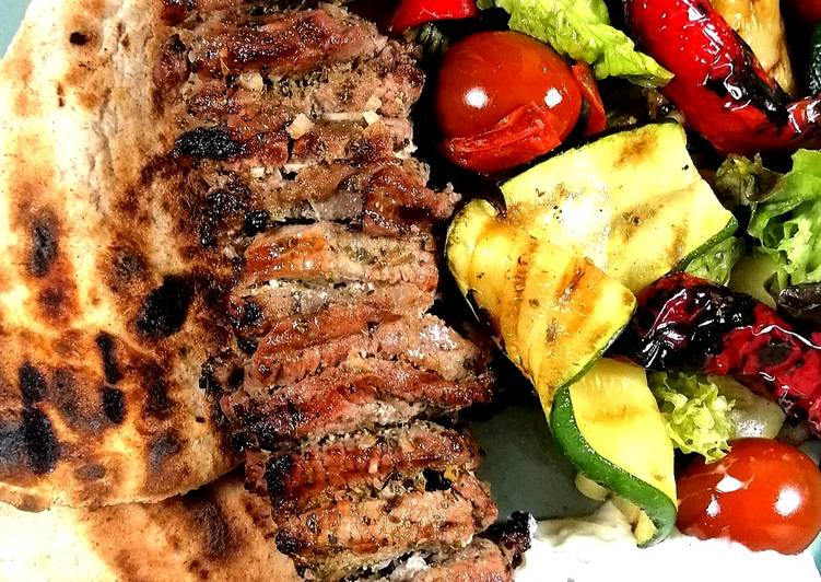 Lamb Souvlaki with grilled vegetables salad and tzatziki sauce Lamb Souvlaki with grilled vegetables salad and tzatziki sauce