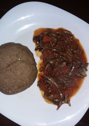 A picture of Stewed Omena served with brown ugali.