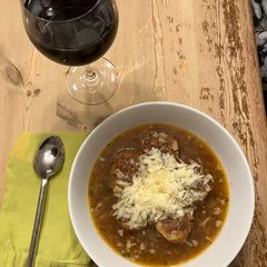 A picture of Onion soup with chicken meatballs.