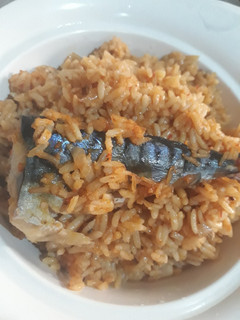 A picture of Jollof rice with fresh fish.