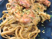 Una foto di pasta gamberi e pistacchio