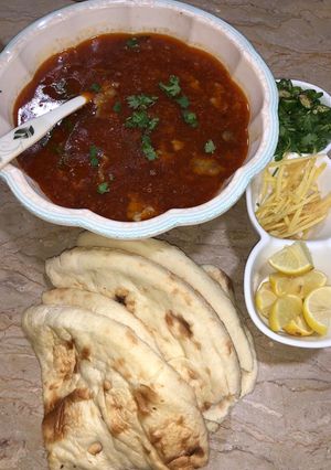 A picture of Nihari with tandoori roti.
