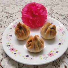 A picture of Baked Modak filled with fresh coconut, jaggery, poppy seeds and nutmeg (made in Air fryer).