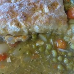 A picture of Chicken pot pie topped with biscuits.