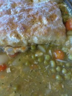 A picture of Chicken pot pie topped with biscuits.
