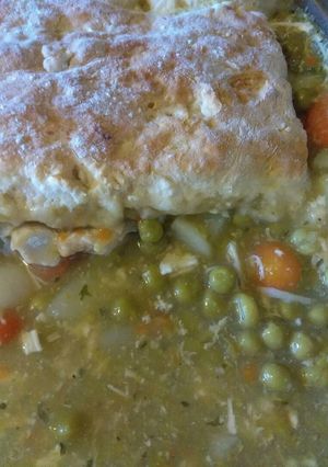 A picture of Chicken pot pie topped with biscuits.