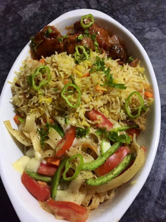 A picture of Egg fried rice with vegetables manchurian.