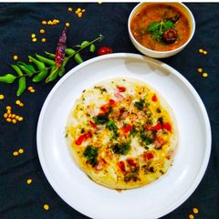 A picture of Tomato and onion uttapam.