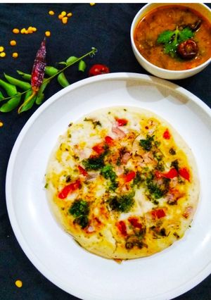 A picture of Tomato and onion uttapam.