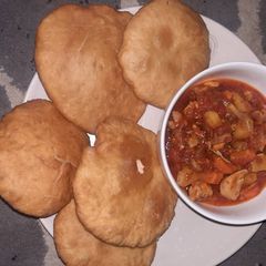 A picture of Poori paratha with potato and vegetables sauce.