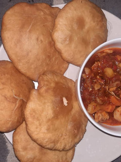 A picture of Poori paratha with potato and vegetables sauce.