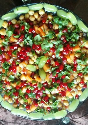 A picture of Chana chat with lots of fruits.