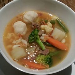 A picture of Beef Soup with Veggies and Fish Balls.