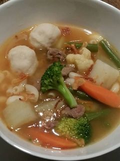 A picture of Beef Soup with Veggies and Fish Balls.