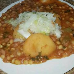 A picture of Githeri with Irish potatoes and steamed cabbages.