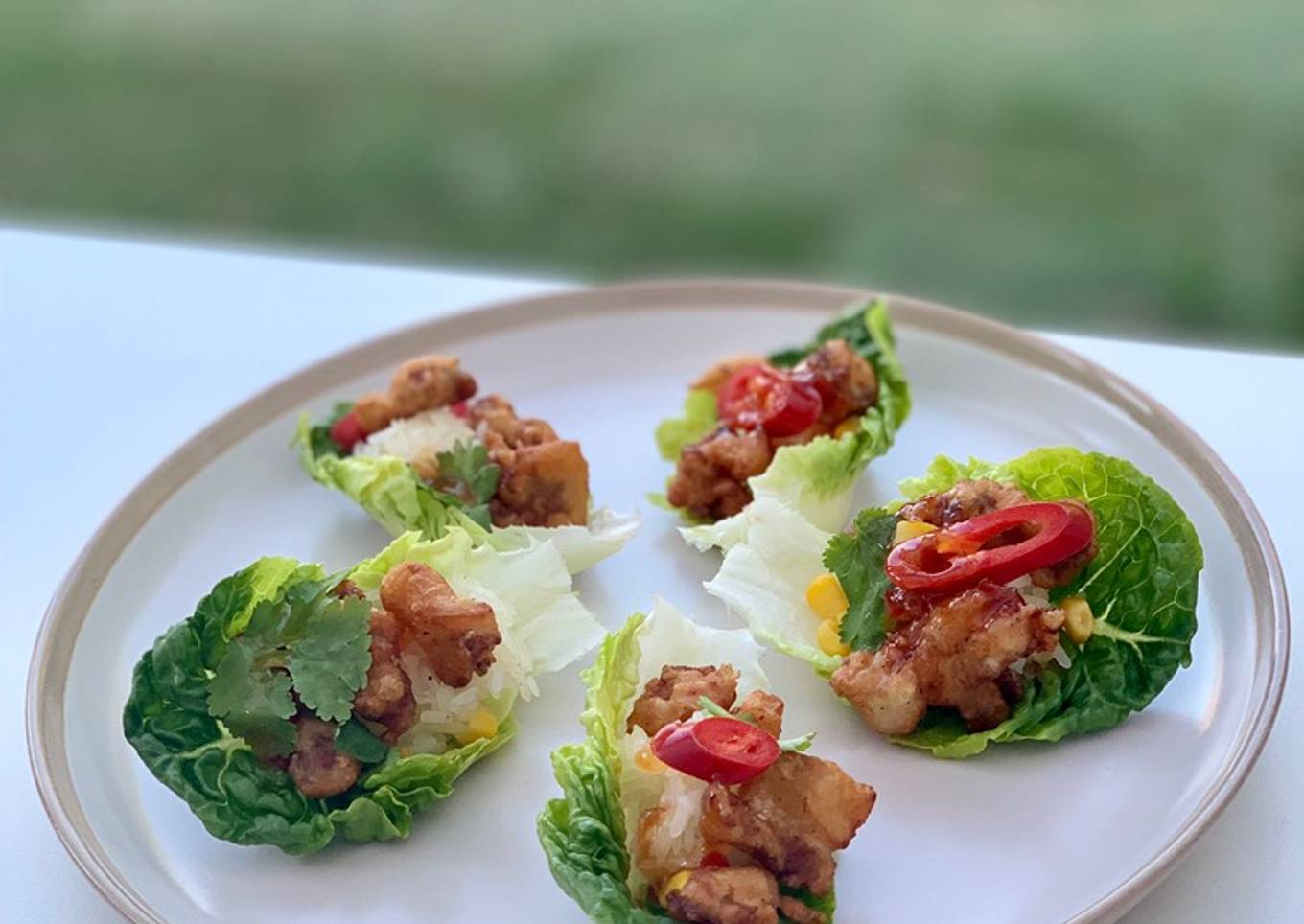 Beer-battered pork popcorn served with sticky rice and sweet chilli sauce, on little gem