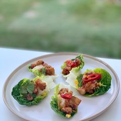A picture of Beer-battered pork popcorn served with sticky rice and sweet chilli sauce, on little gem.