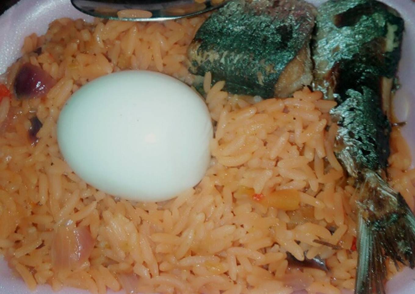 Delicious jollof rice wix boiled egg md fish