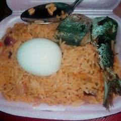 A picture of Delicious jollof rice wix boiled egg md fish.