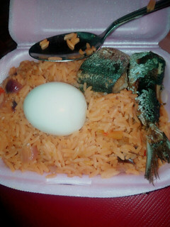 A picture of Delicious jollof rice wix boiled egg md fish.