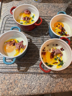 A picture of Baked eggs with cheddar and bacon.