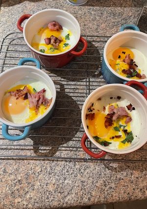 A picture of Baked eggs with cheddar and bacon.