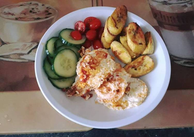 Simple Way to Make Favorite Fried plantain with fried egg served with cucumber and fresh tomatoes