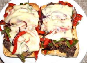 Una foto de Churrasco de lomo sobre tostadas de pan ciabatta con pimientos y cebolla