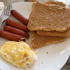 A picture of Eggs Sausages Brown Bread and Peanut Butter.