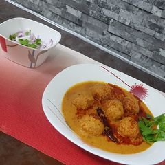 A picture of Paneer kofta in spicy gravy.