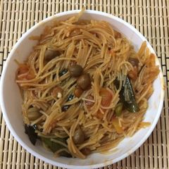 A picture of Vermicelli Upma with brown ChanaSatvik.