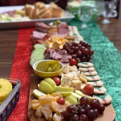 A picture of Christmas charcuterie board/mini sandwiches.