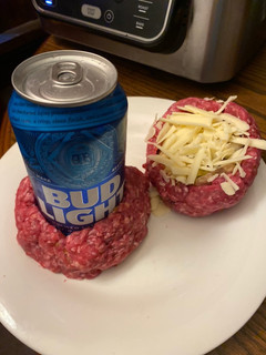 A picture of Air Fryer beer bottle stuffed bacon burgers.