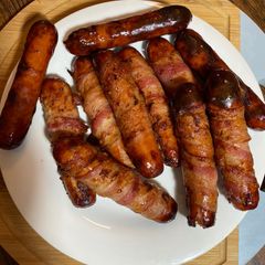 A picture of Bacon wrapped cheddar Brats.