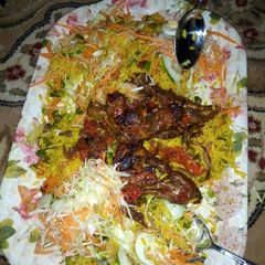 A picture of Fried rice with pepper chicken and salad.
