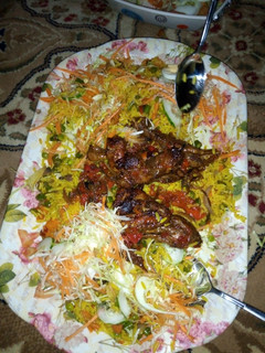 A picture of Fried rice with pepper chicken and salad.
