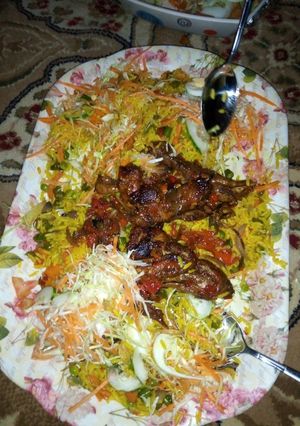 A picture of Fried rice with pepper chicken and salad.